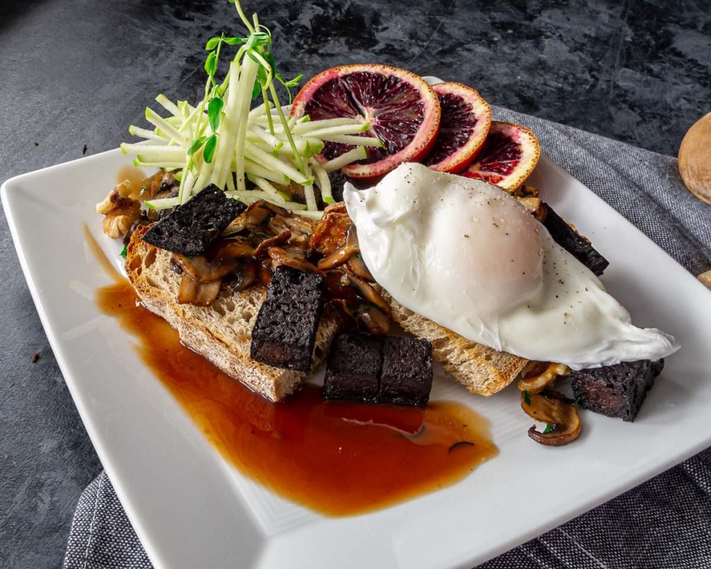 Poached eggs and blood sausage on toast