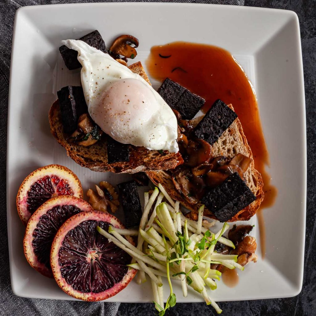 Poached eggs and blood sausage on toast